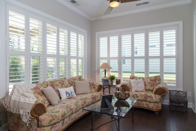 Airy sunroom with faux wood shutters in Honolulu.